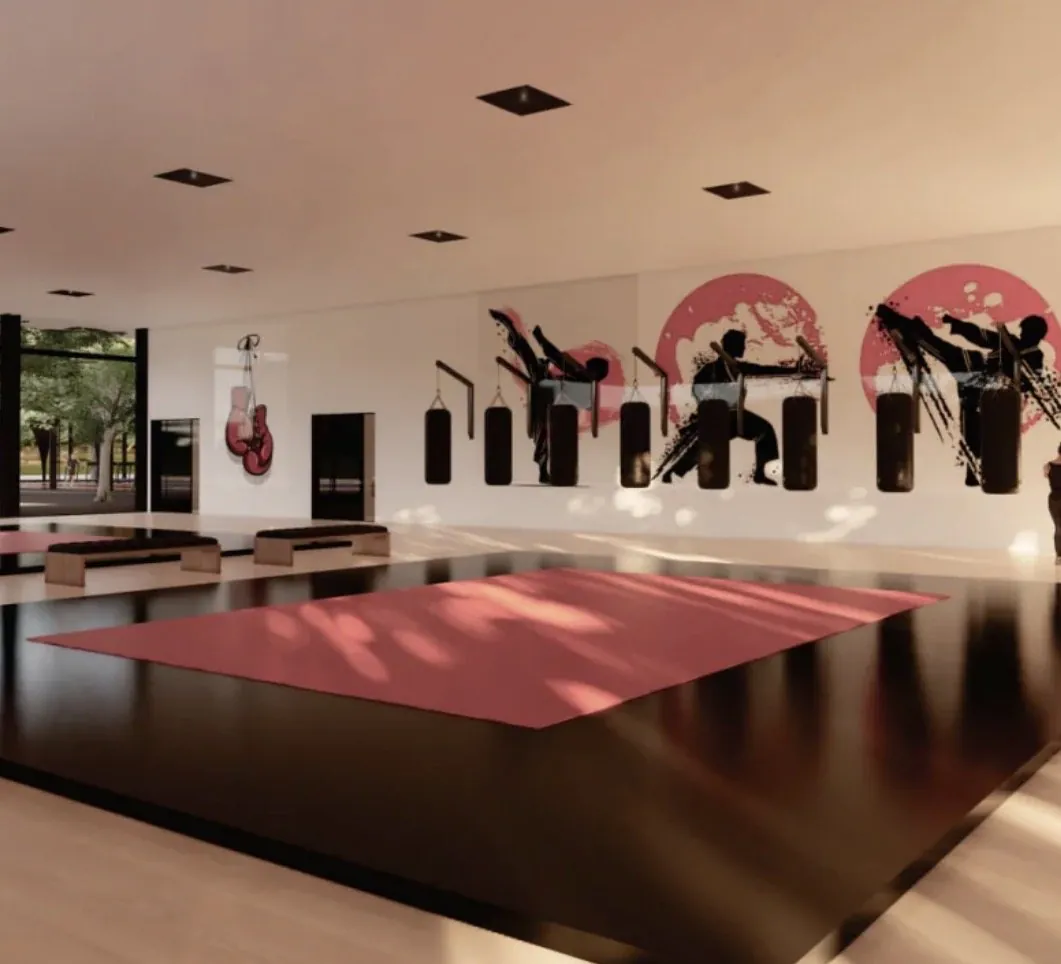Perspectiva de sala de lutas com tatame e sacos de pancada